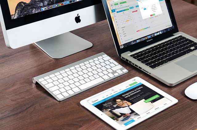 iPad à côté d'un imac et un macbook
